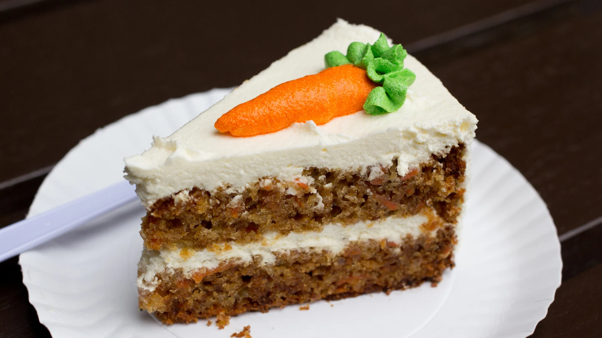 Slice of carrot cake on plate.